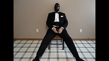 Seated In A Tuxedo Wearing A Rubber Cock And Ball Sheath And Playing With My Cock Until I Cum.