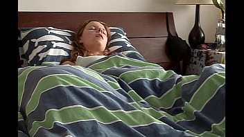 Cute Redhead Pleasures Herself Under And Above The Covers